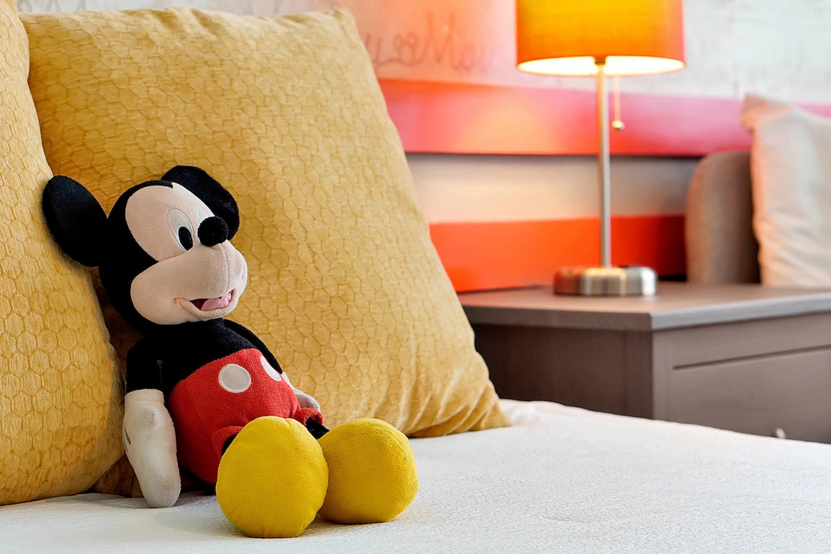 Mickey Mouse plush in Disney-themed bedroom